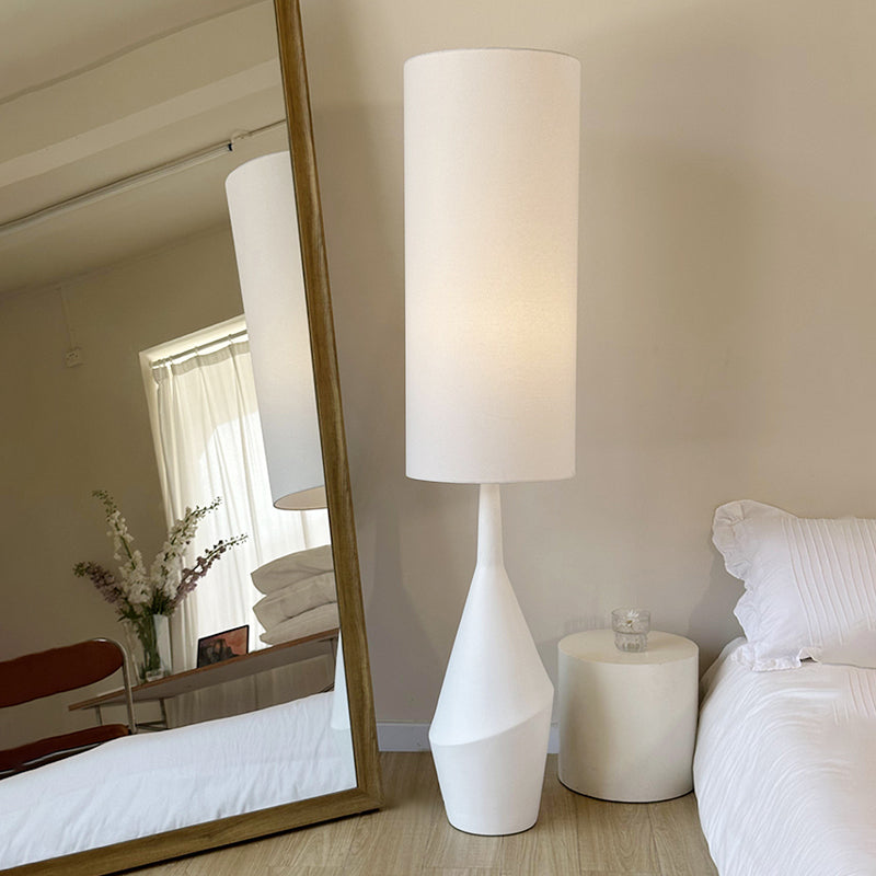 The Nordic Elegance Cream LED Floor Lamp showcasing its elegant design in a modern bedroom.