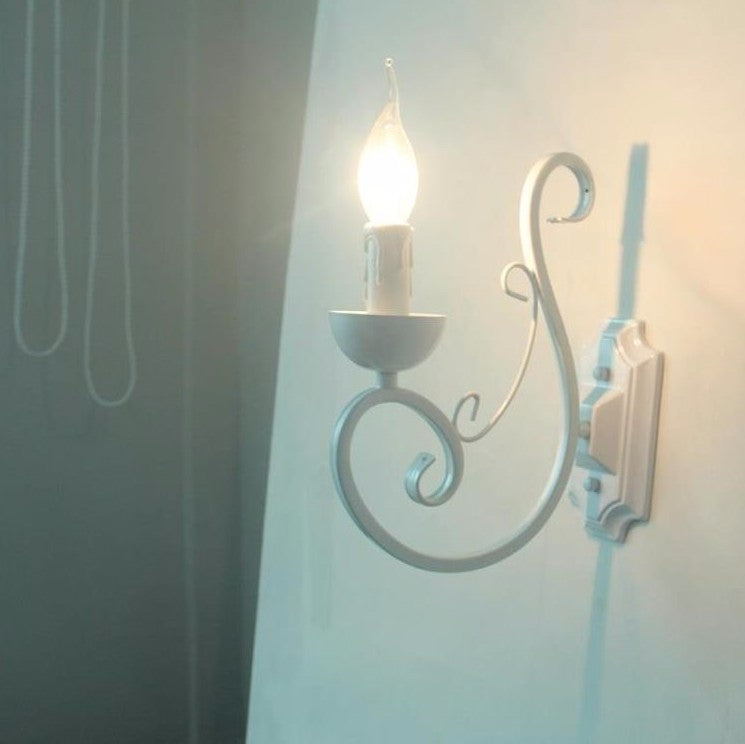 Elegant white E14 LED candle wall lamp with adjustable swing arm, ideal for a cozy bedroom ambiance.