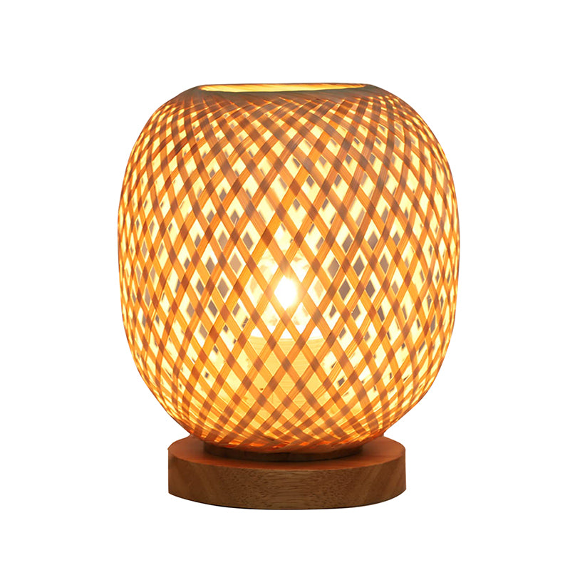 Stylish rattan lamp on a bedside table, illuminating a boho-inspired nursery with warm light.