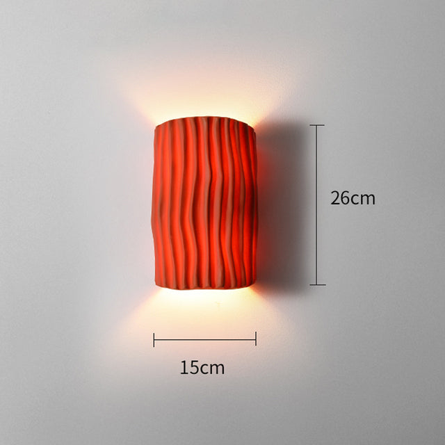 The modern wall light installed in a cozy living room setting