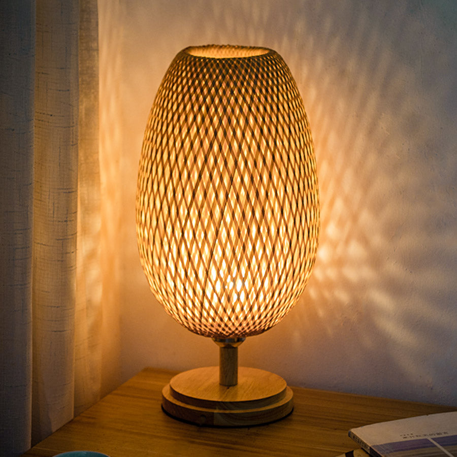 Side view of rustic bamboo table lamp showcasing its unique woven design.