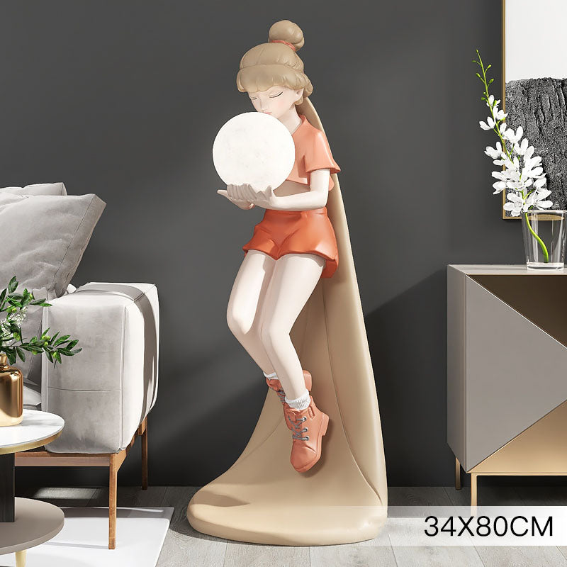 Trendy long-haired girl sculpture floor lamp in a cozy living room setting, showcasing its warm glow.