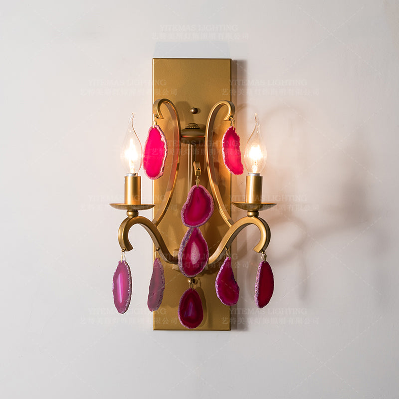 Close-up of the pink agate wall lamp demonstrating its polished surface and vibrant colors.