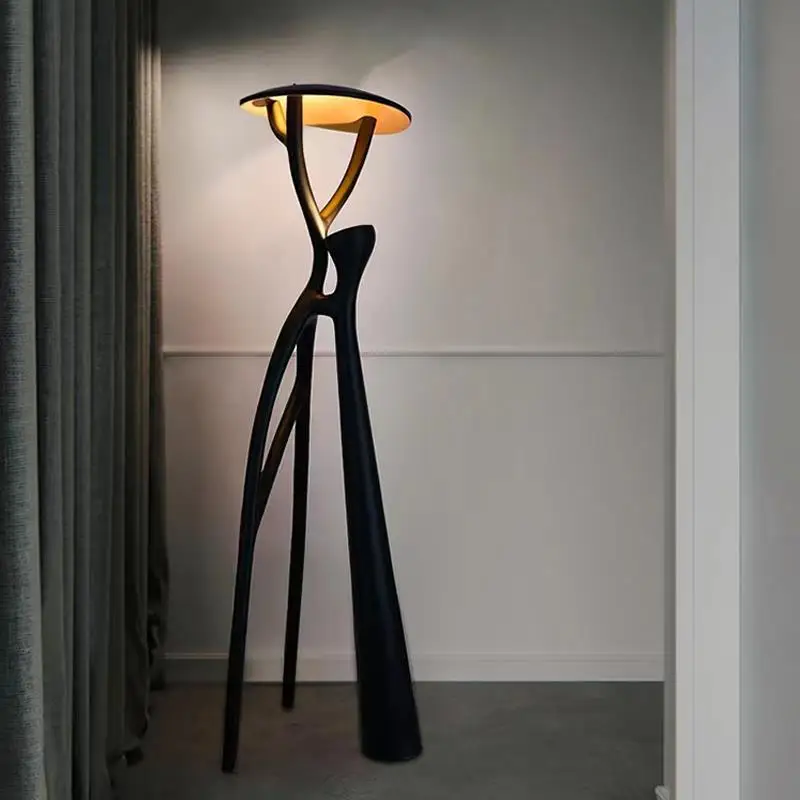 Elegant black LED floor lamp in a cozy living room setting, showcasing its stylish design.