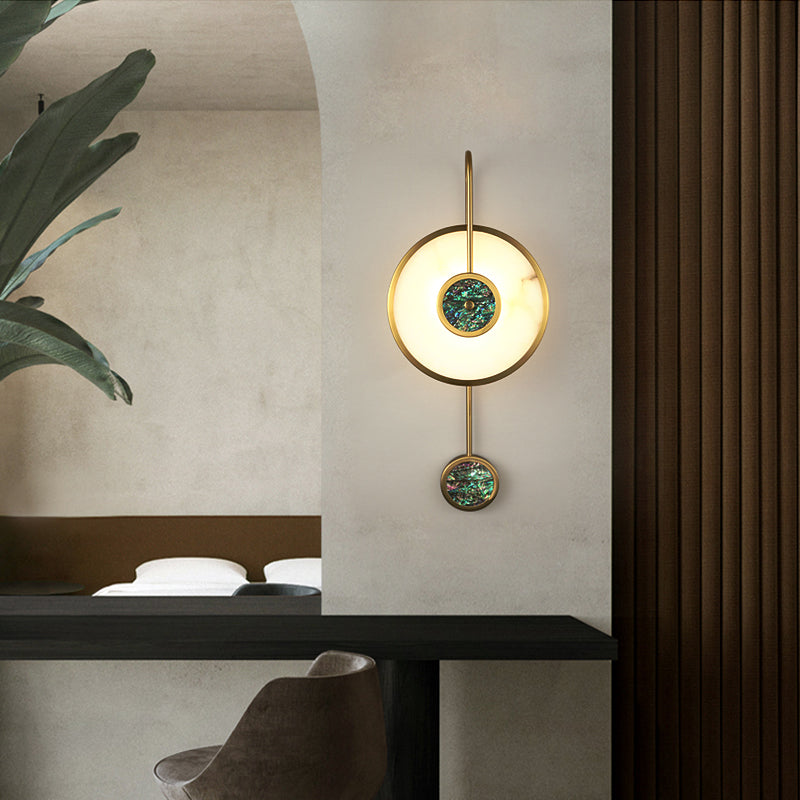 Elegant gold copper wall sconce illuminating a stylish hallway, adding warmth and ambiance.