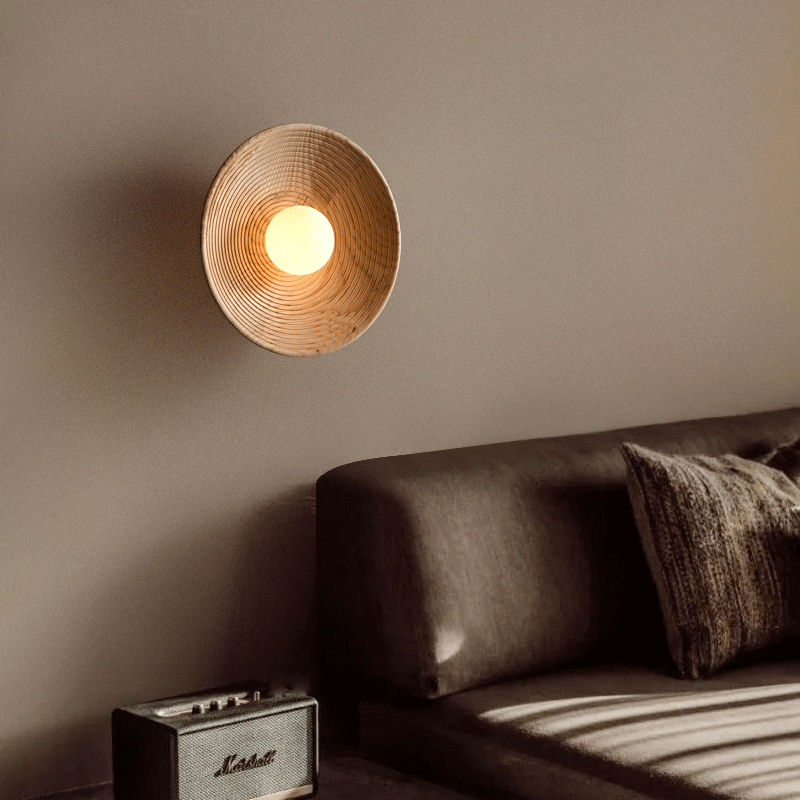 The wall lamp illuminating a bedroom with a soft, warm glow.