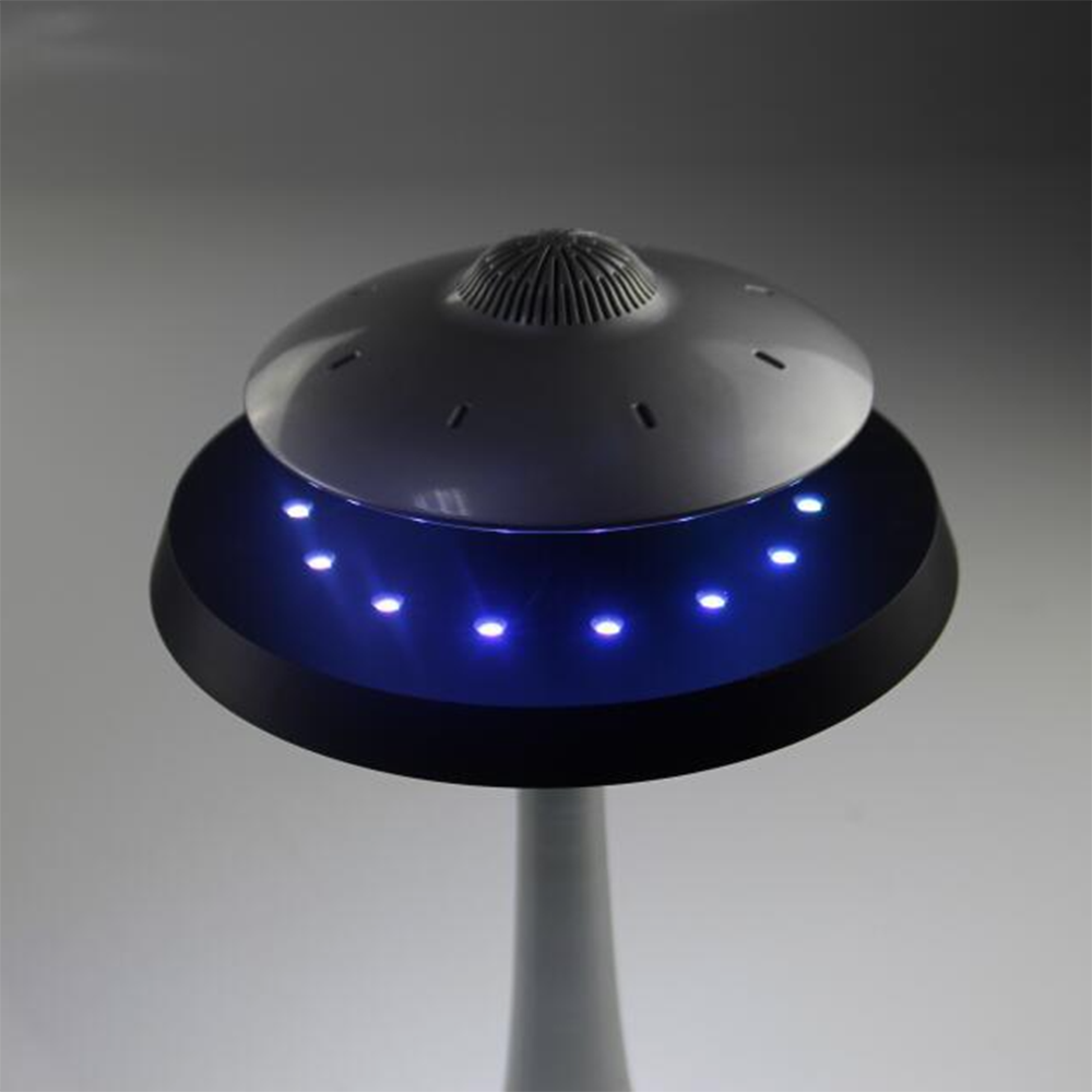 The UFO 3D smart table lamp in a cozy bedroom setting, creating a warm ambiance.