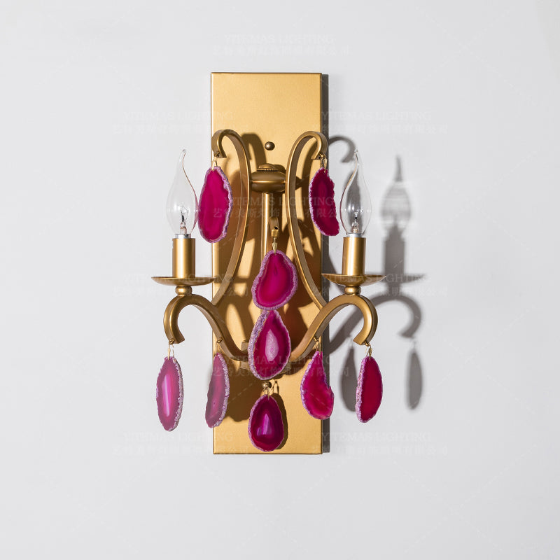 Art Deco style pink agate wall lamp illuminating a modern dining area.