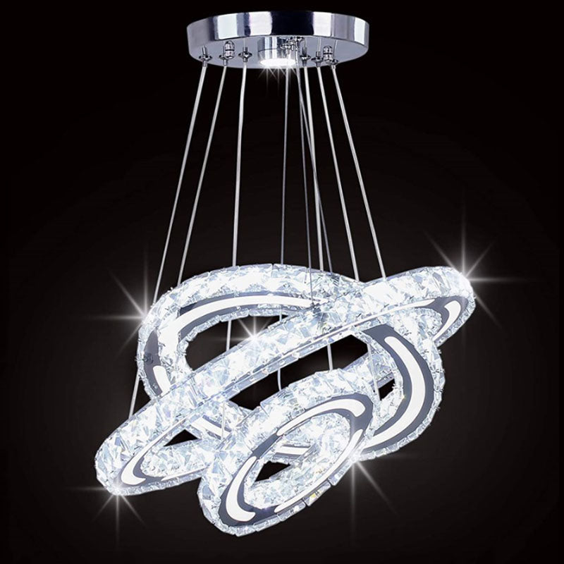 Installation of the adjustable crystal pendant light in a high-ceiling living area.