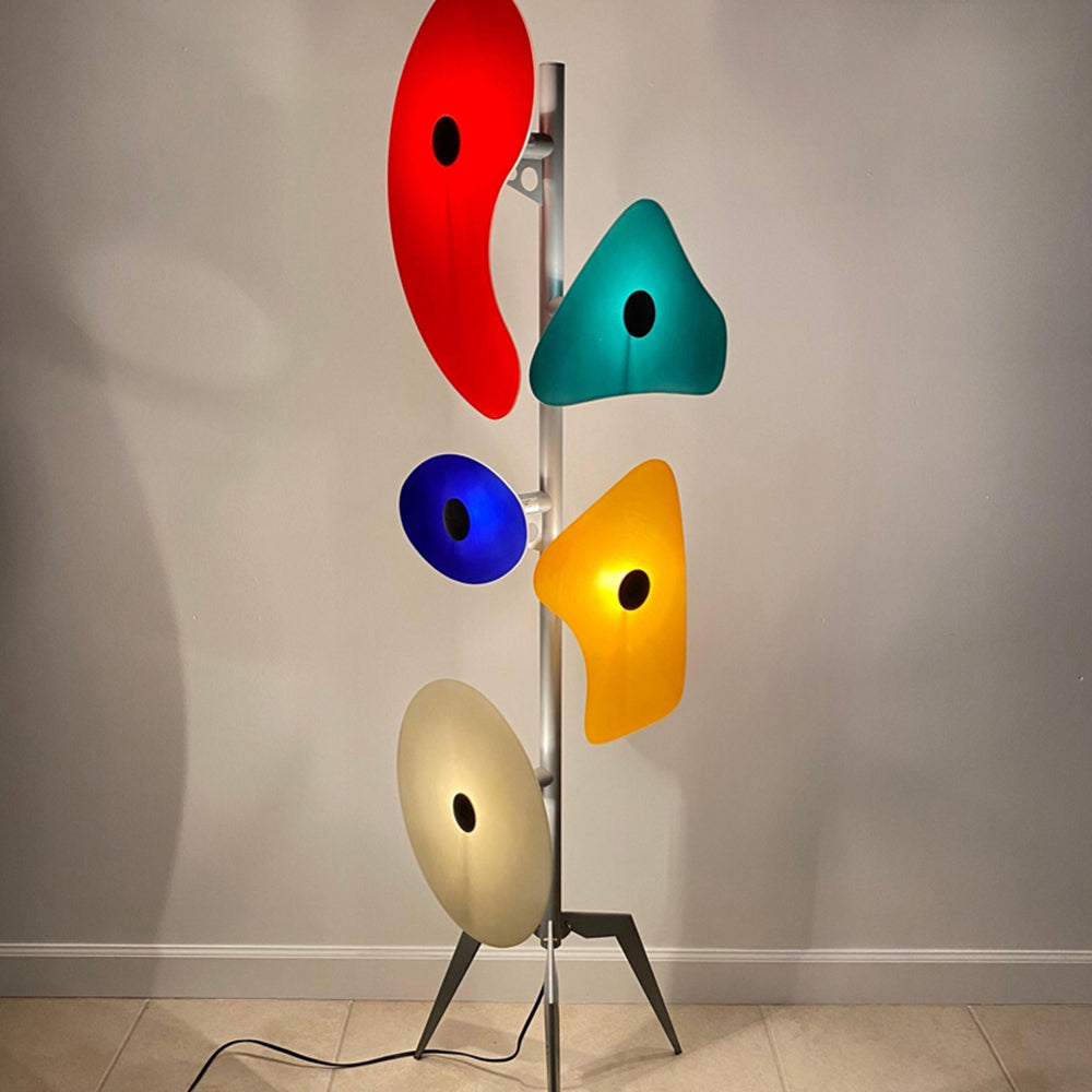 The Elegant Orbital Floor Lamp illuminating a cozy reading nook with its soothing light.