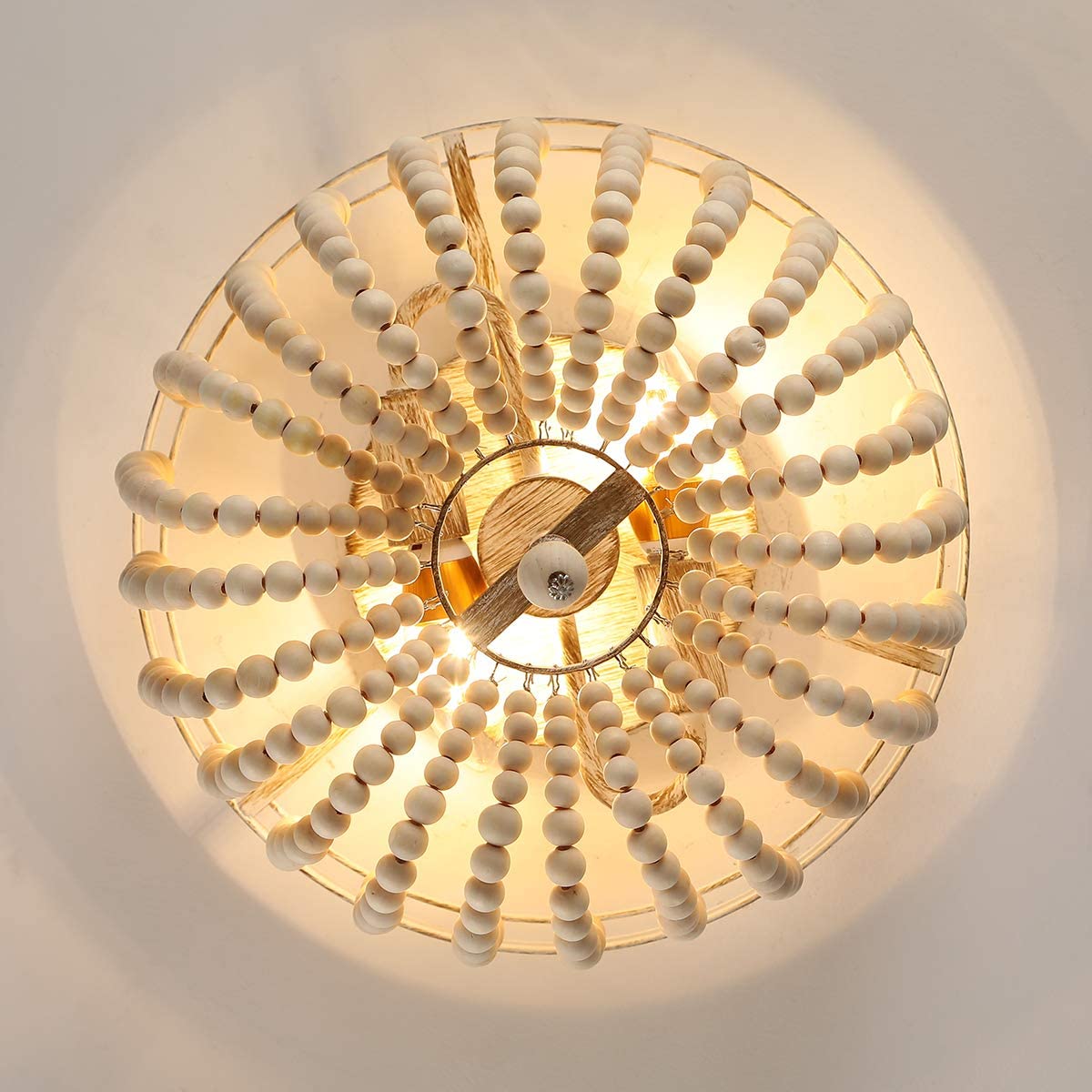 Rustic wood beaded ceiling light illuminating a cozy dining area.