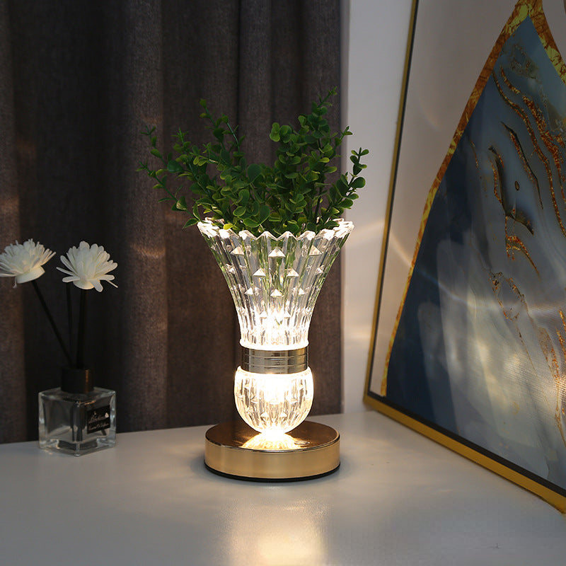 Elegant crystal vase LED table lamp showcasing flowers on a dining table.