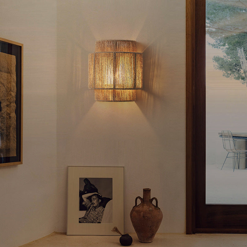 Close-up of the Bohemian Rattan Wall Lamp showcasing its intricate weave and warm glow.