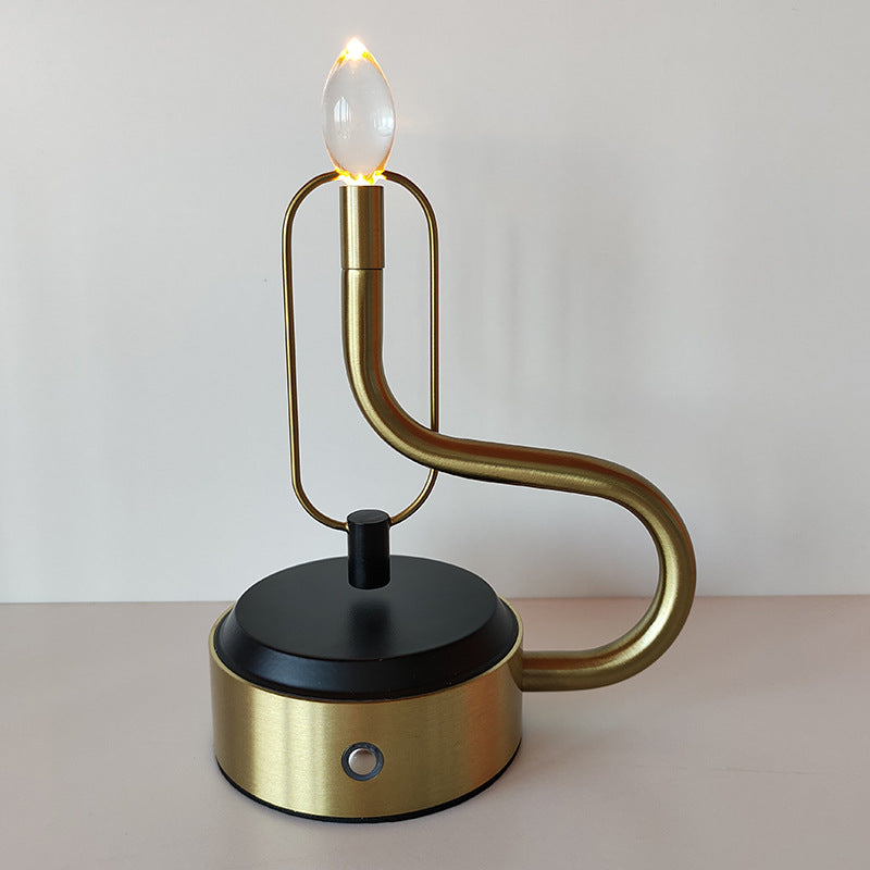 Luminous Flame Table Lamp on a bedside table, creating a warm ambiance in the bedroom.