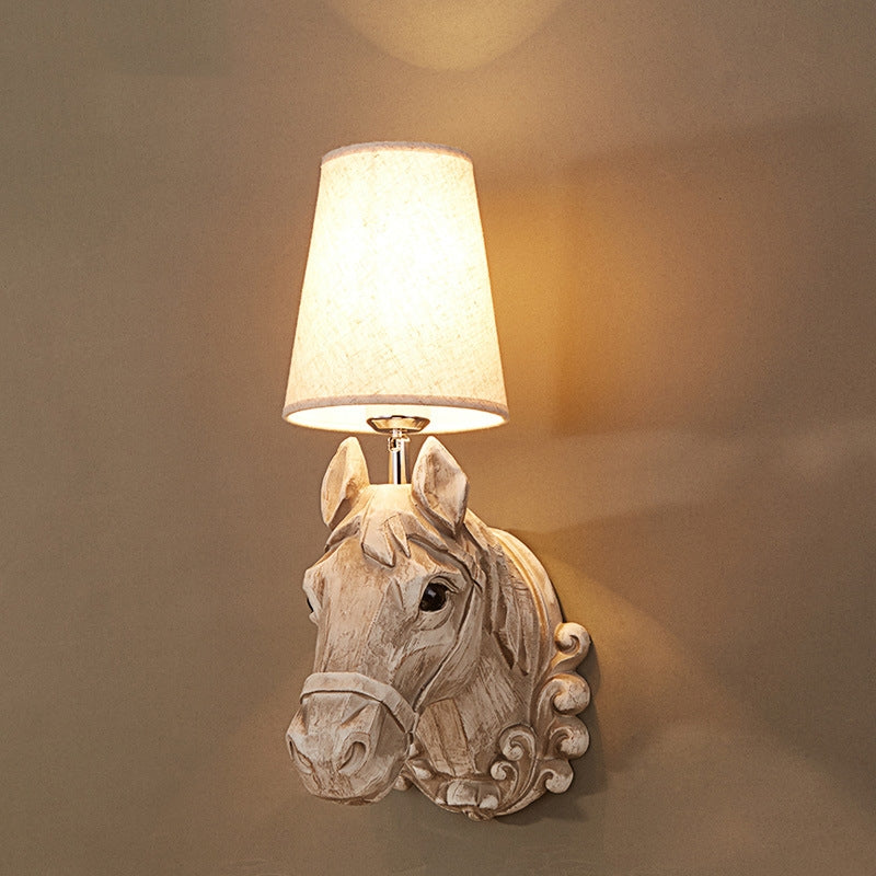 Rustic Horse Resin Wall Lamp installed in a cozy living room, illuminating the space with warm light.