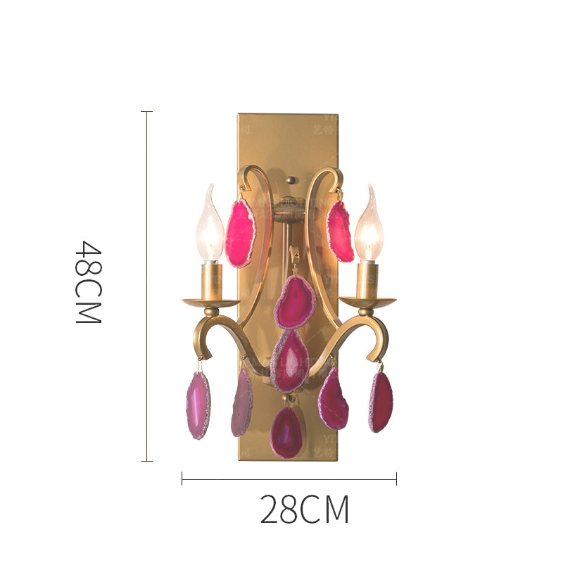 Close-up of the pink agate wall lamp demonstrating its polished surface and vibrant colors.