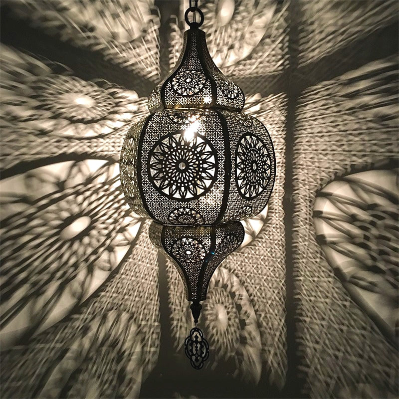 Moroccan vintage pendant light hanging in a dining room, showcasing its intricate designs.