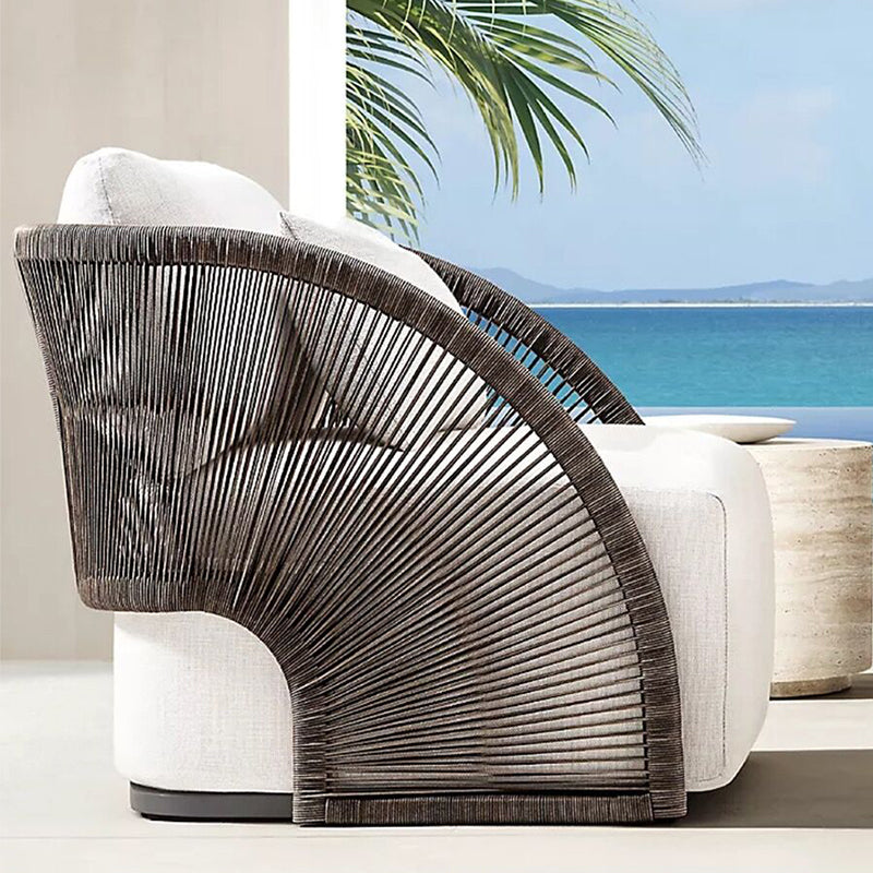 Close-up of the weather-resistant fabric on the rattan outdoor sofa, highlighting quality and durability.