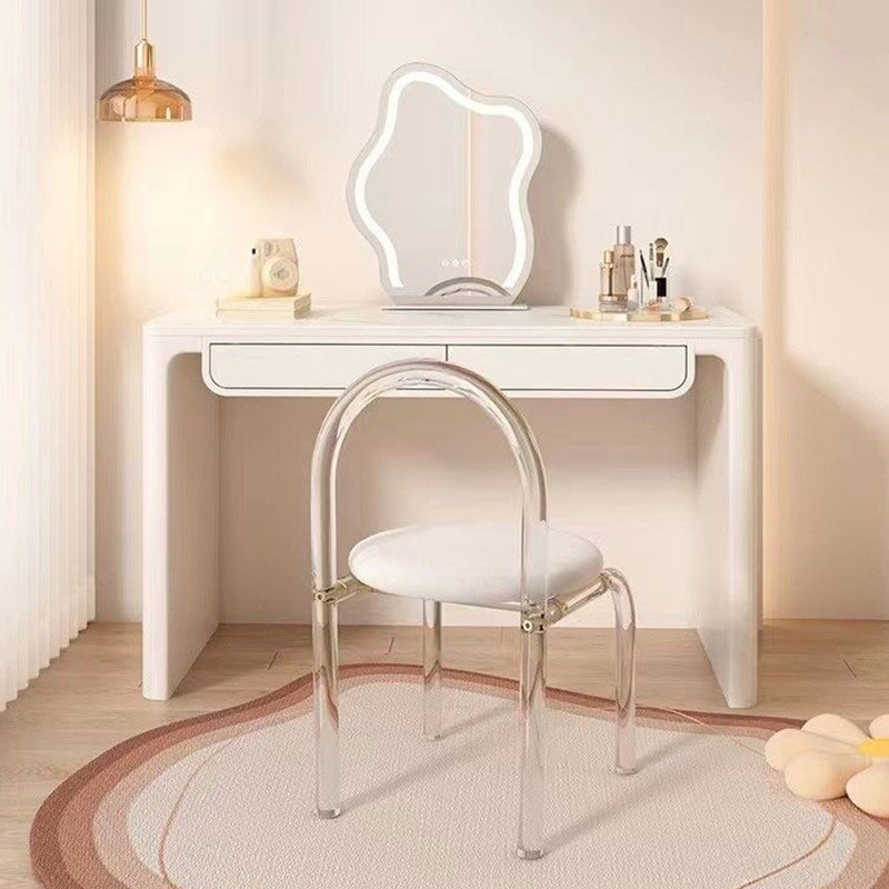Elegant marble makeup vanity with mirror and stool showcasing spacious design and storage.