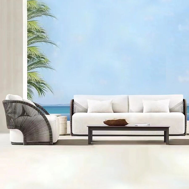 Elegant rattan outdoor sofa set showcasing modern design and comfort from a side angle.