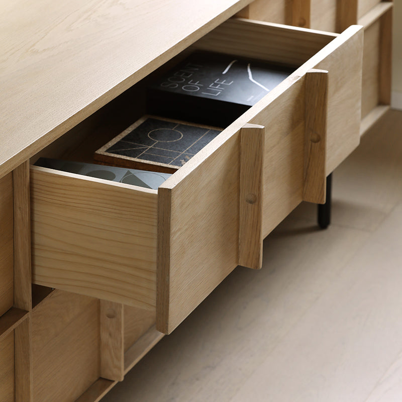 Side view of the TV stand highlighting the walnut veneer finish and spacious compartments.