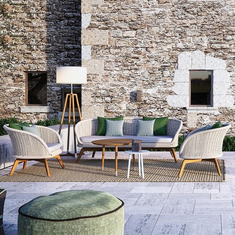 Close-up of the Elegance Rattan and Teakwood Patio Set highlighting the plush cushions and handwoven design.