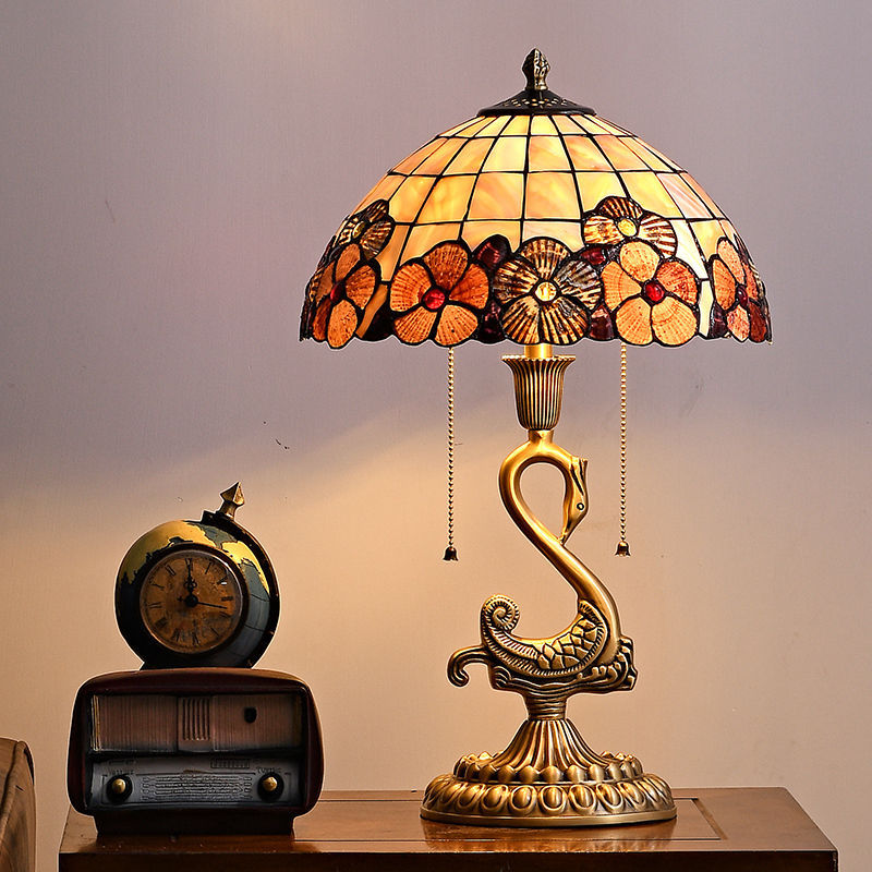 Elegant Swan Brass Table Lamp in a cozy living room setting, providing soft ambient lighting.