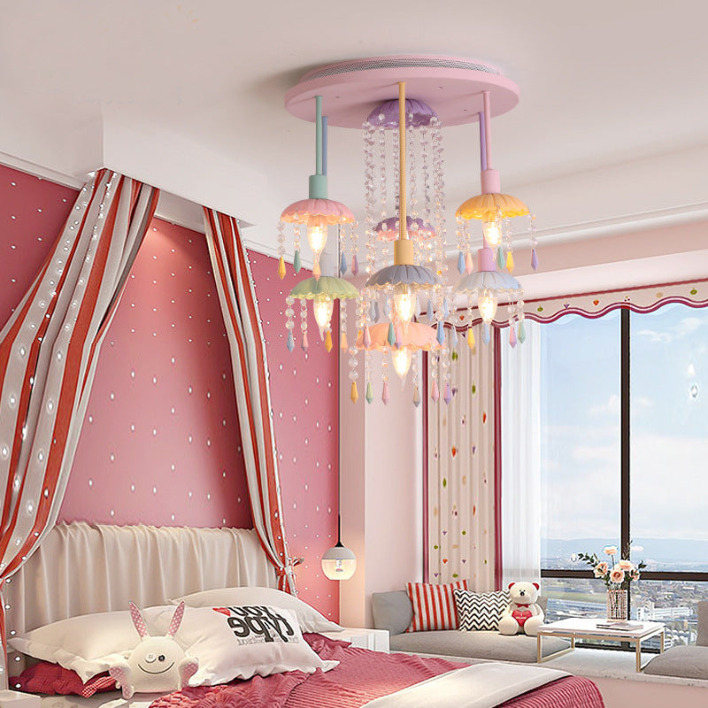 The Macaron chandelier illuminated in a cozy living room setting.