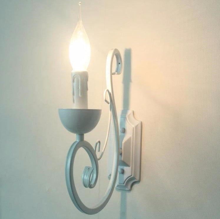Elegant white E14 LED candle wall lamp with adjustable swing arm, ideal for a cozy bedroom ambiance.