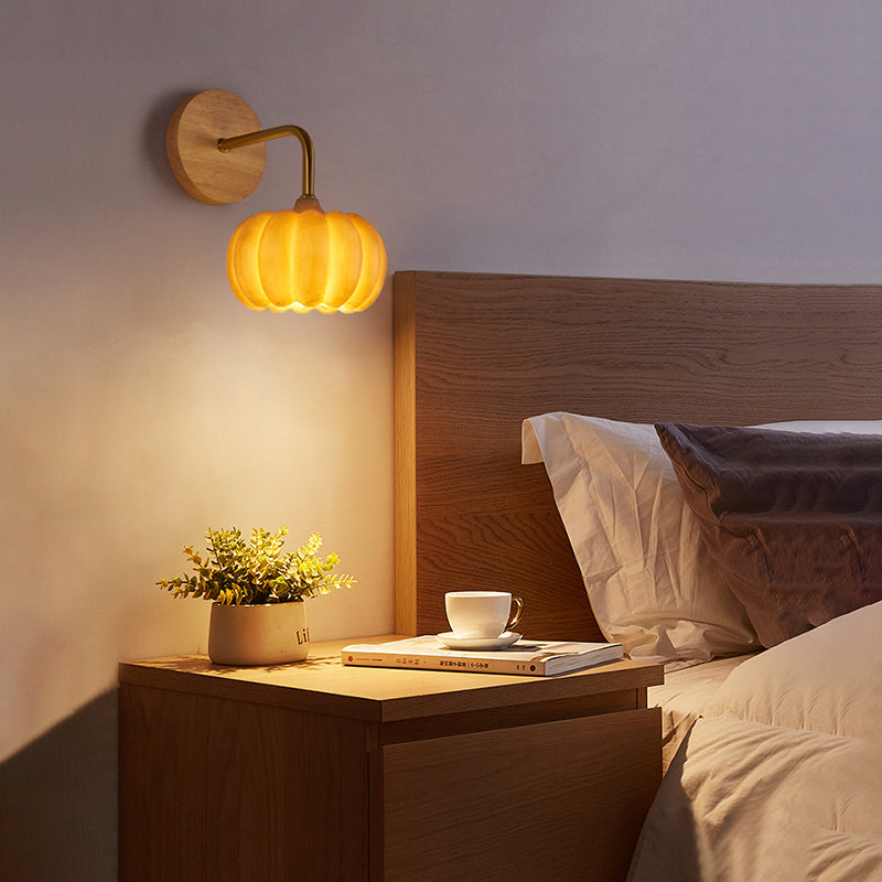 Charming pumpkin LED wall lamp mounted in a cozy living room setting