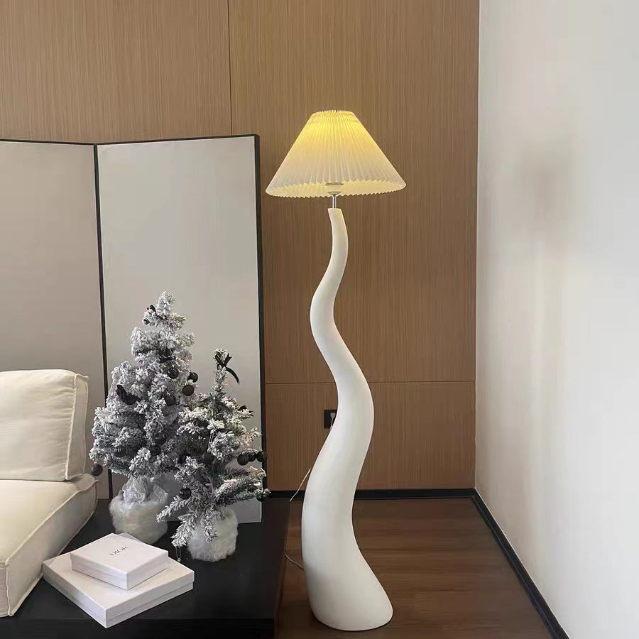 Close-up of the handcrafted resin body of the floor lamp, highlighting its unique organic shapes.