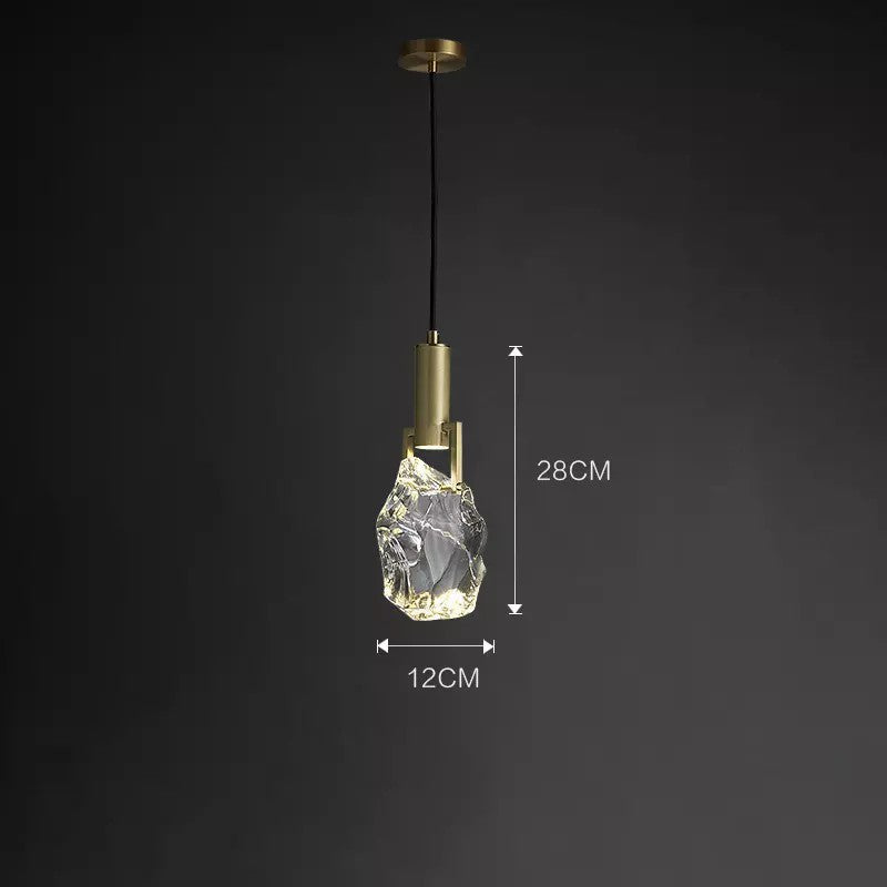 Elegant crystal pendant light illuminating a modern bedroom setting.