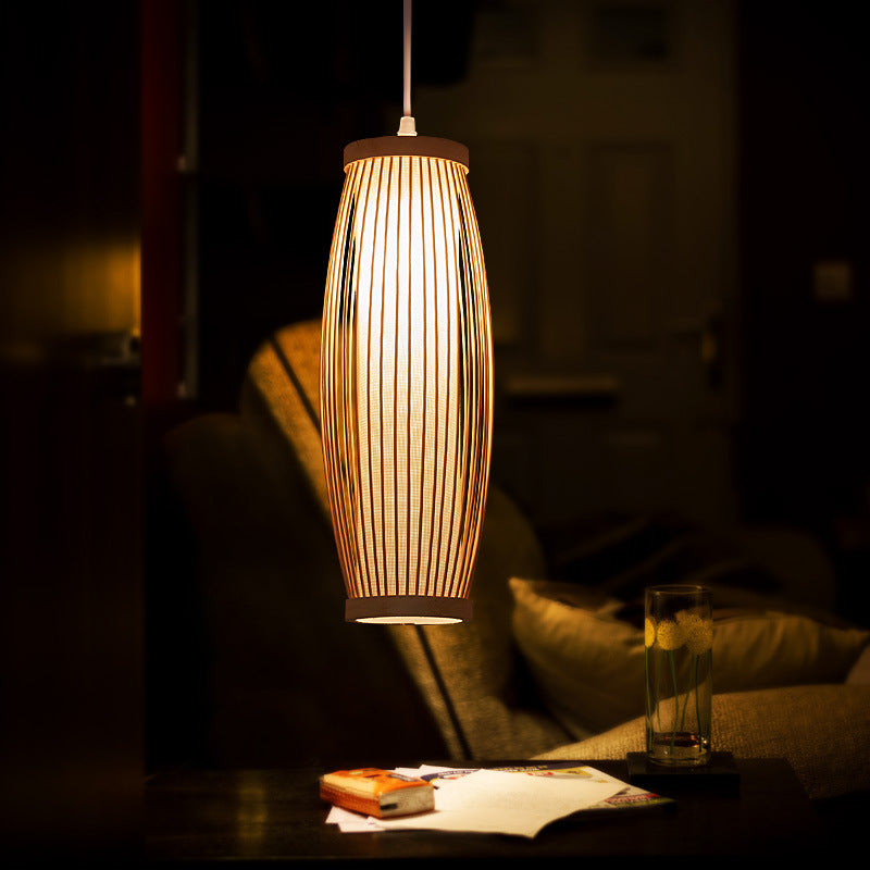 Elegant handwoven bamboo lantern pendant light in a cozy living room setting.