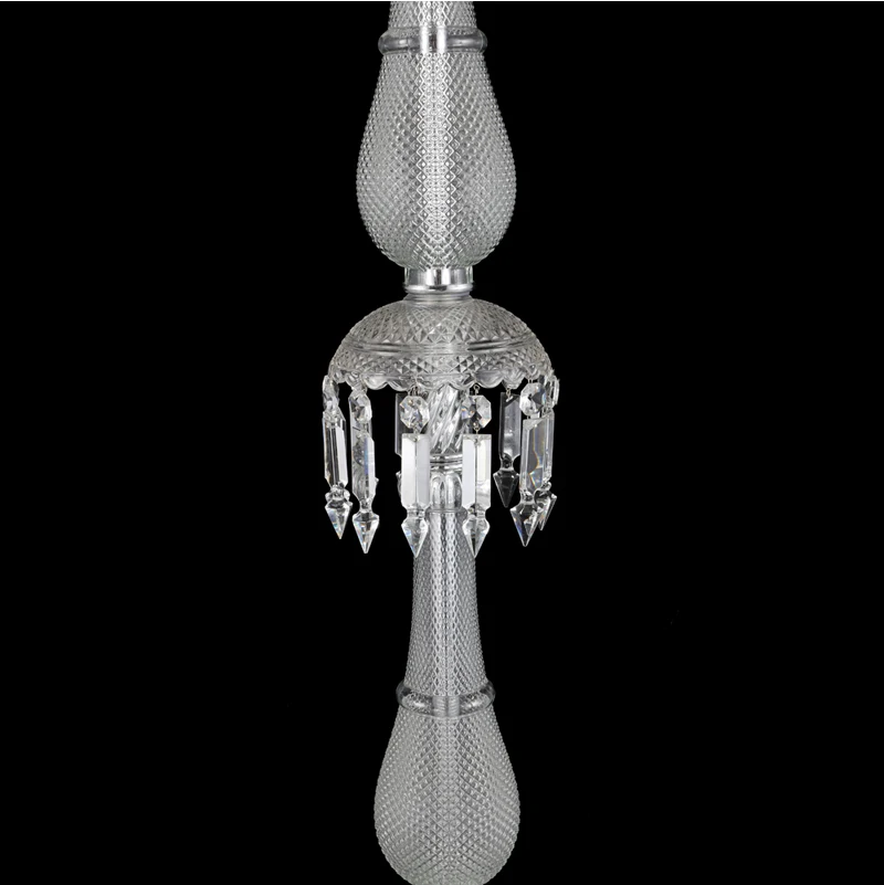 The sleek design of the crystal lamp adds charm to a well-decorated bedroom.