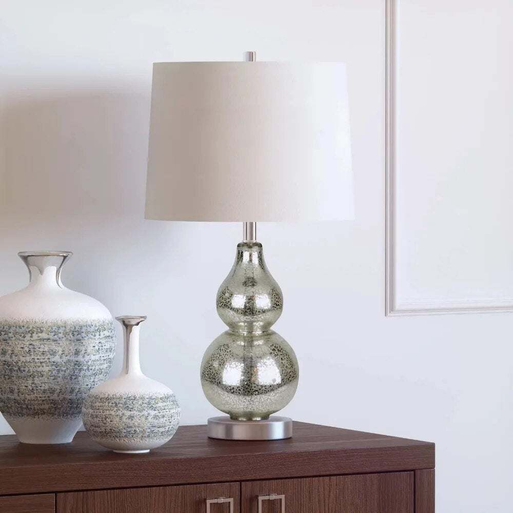 Close-up view of the gourd-shaped base of the metal lamp, showcasing its smooth texture and unique design.