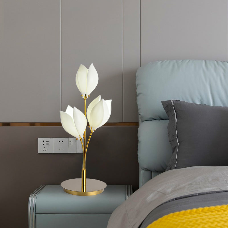Elegant ceramic magnolia flower lamp on a bedside table with soft lighting