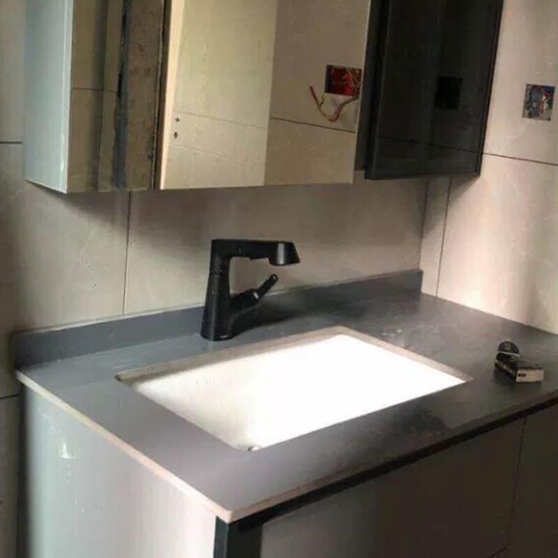 Side angle view showing retractable brass faucet fully extended above small sink