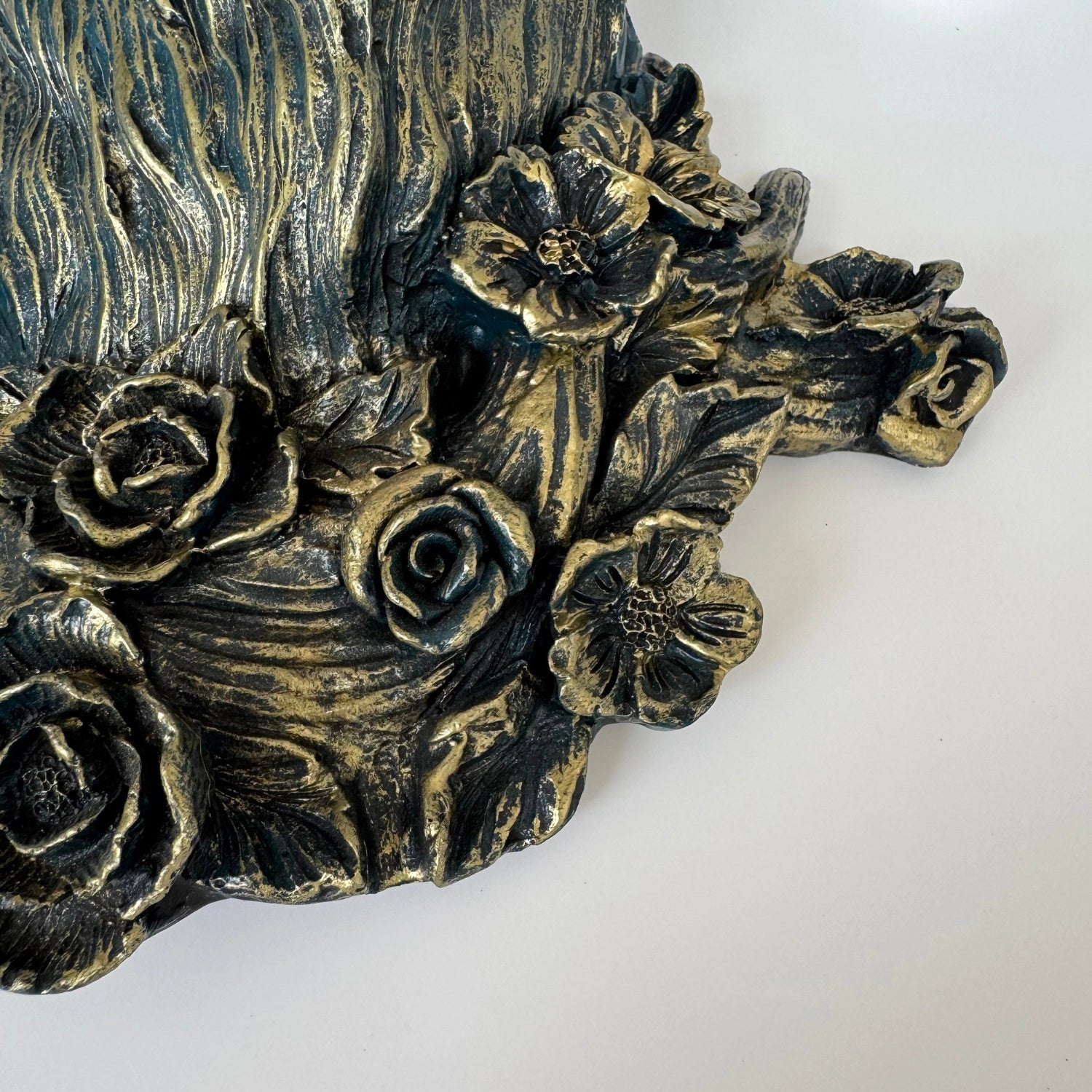 Front view of the deer wall sconce in white finish with floral antlers mounted in a cottagecore bedroom.