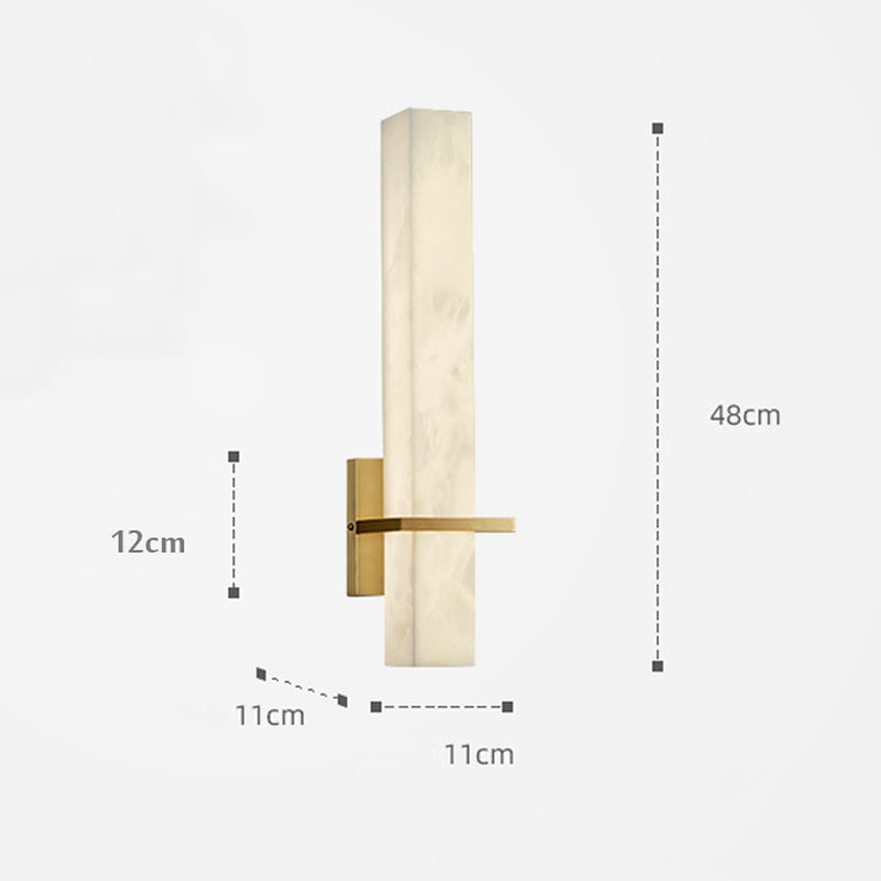 Elegant marble LED wall lamp with golden base, displayed in a stylish bedroom.
