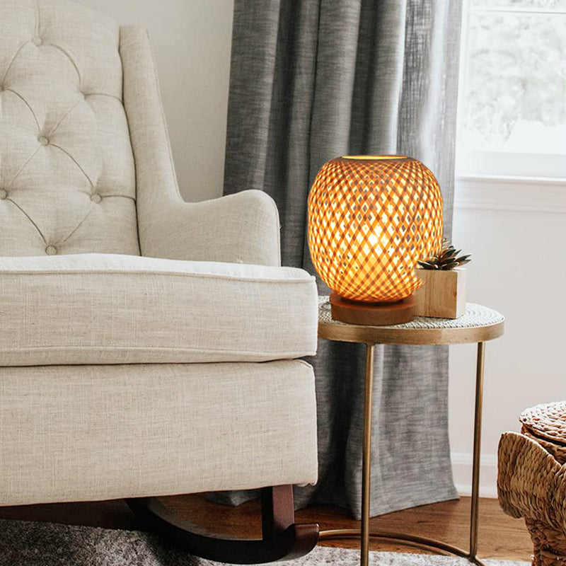 Dimmable handwoven rattan table lamp showcasing its intricate design, perfect for a cozy bedroom environment.