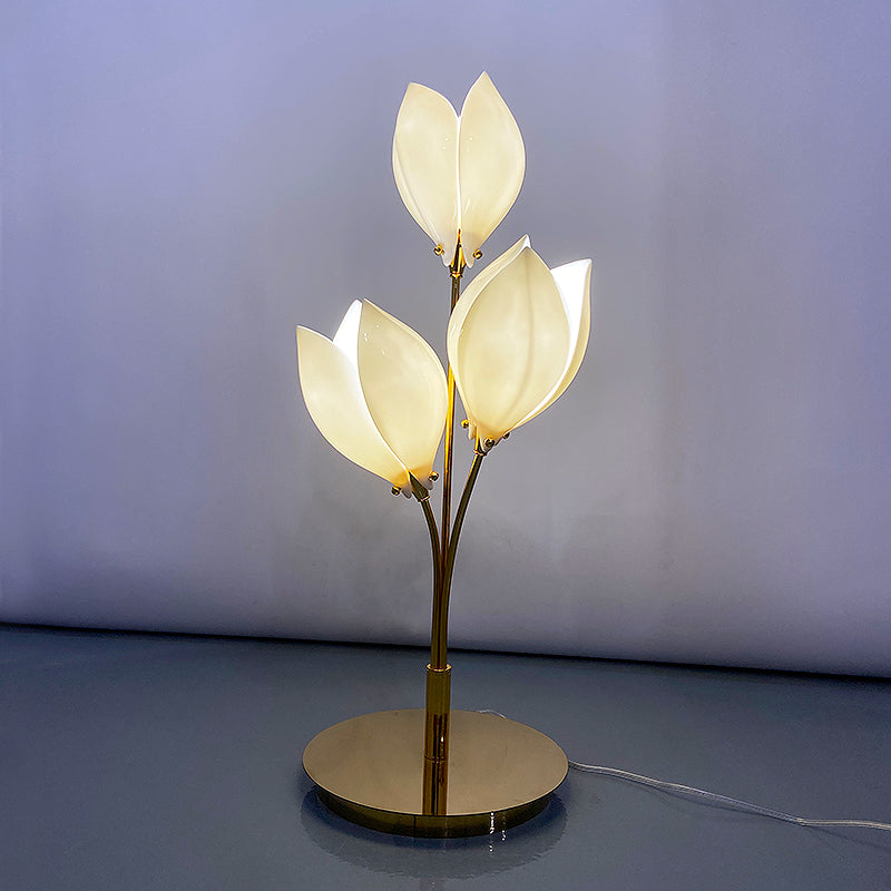 Ceramic magnolia flower lamp illuminating a cozy restaurant table setting