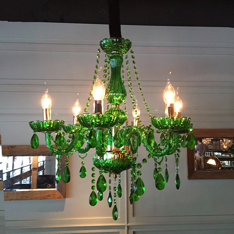 Elegant green LED crystal chandelier in a stylish dining room setting.