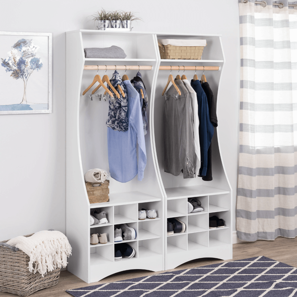 Side angle of compact wardrobe with hanging clothes and shoes