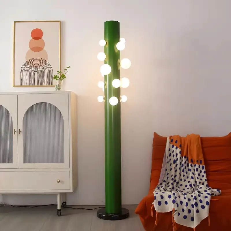 Elegant green cylinder glass floor lamp showcasing its intricate design and opal glass diffusers.