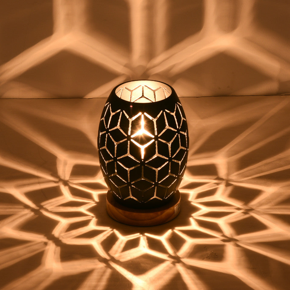 Close-up of the touch control feature on the elegant black patterned table lamp, perfect for bedside use.