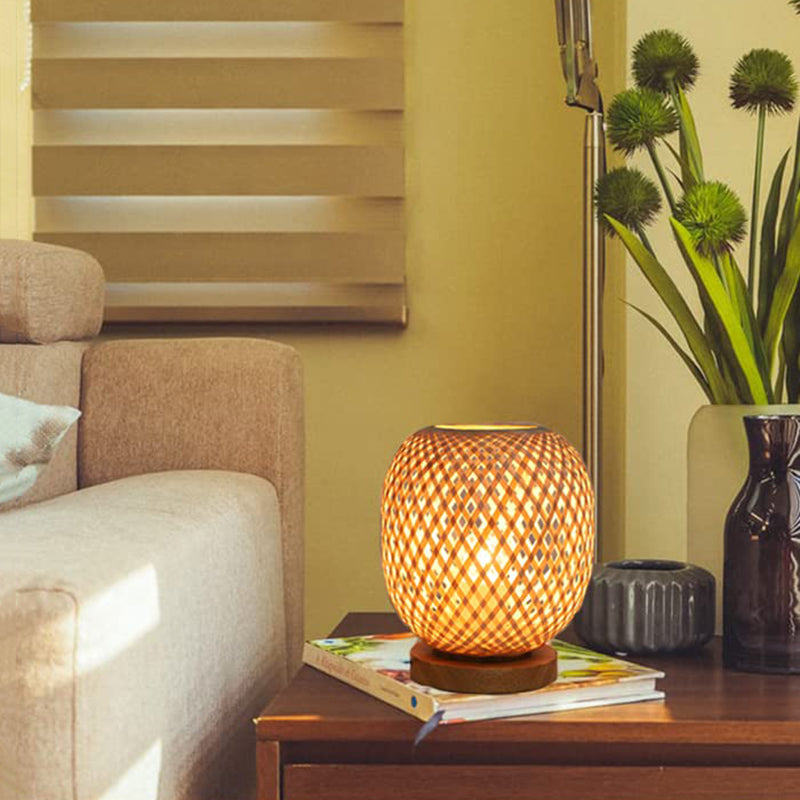 Stylish rattan lamp on a bedside table, illuminating a boho-inspired nursery with warm light.