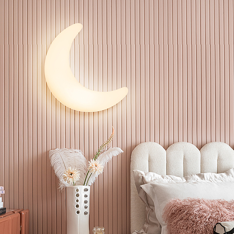 Crescent moon wall sconce illuminating a hallway with a warm glow.