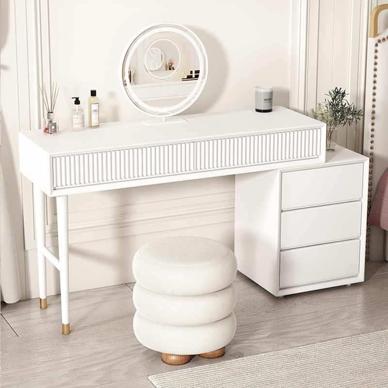 Chic white round upholstered vanity stool with natural wood legs in a modern dressing area.