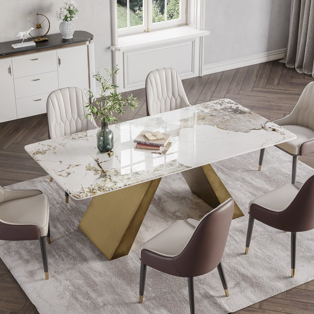 Elegant white marble dining table with curved edges and golden base in dining room setting.