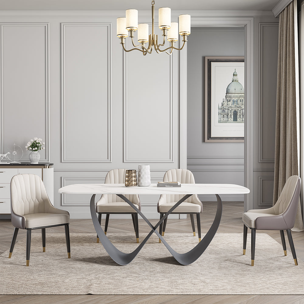 Elegant white butterfly dining table showcasing the sintered stone top and steel base from a side angle.